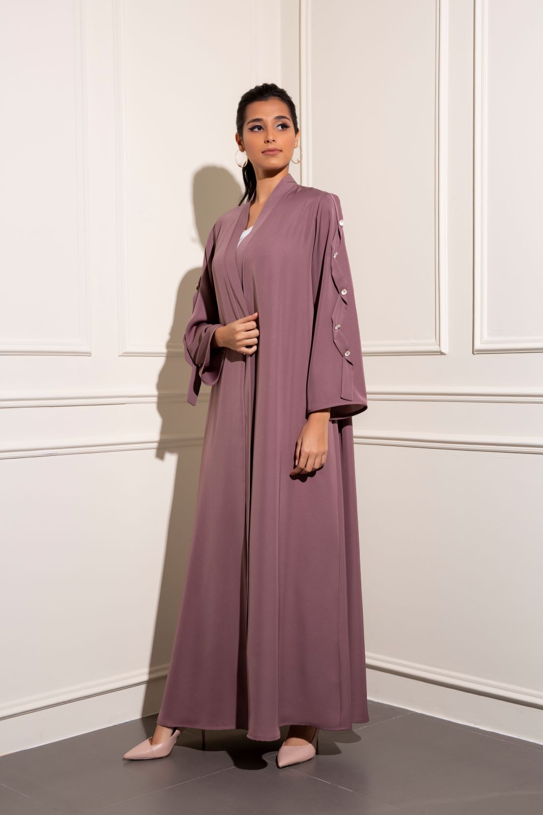 Classic abaya with tone on tone ribbon and pearl button details this classic abaya