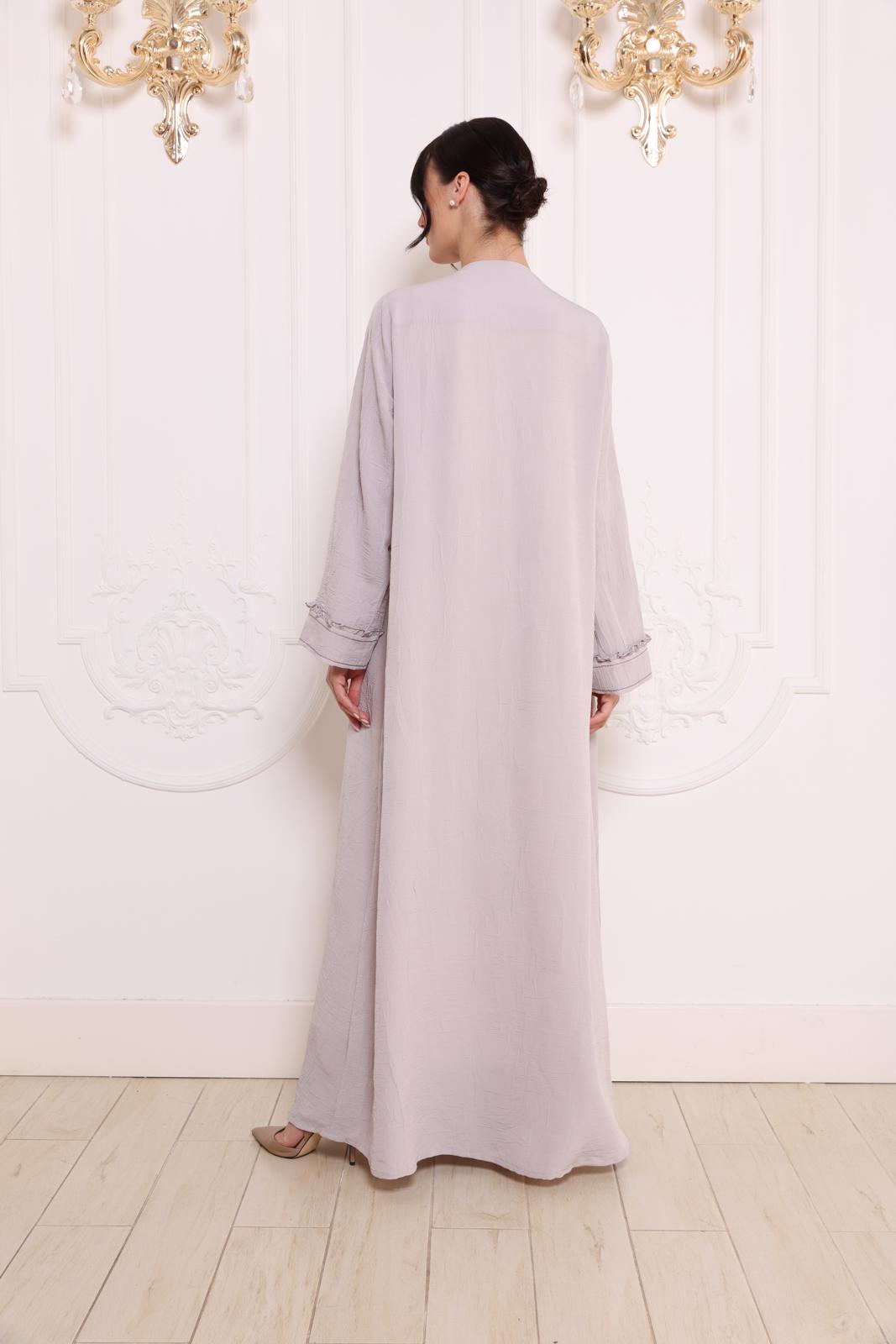 Pleated patch pockets Abaya with ruffle detailed cuffs.